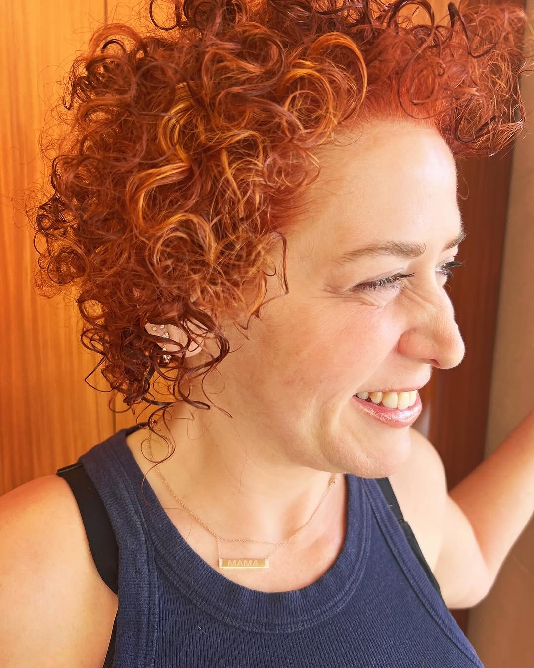 Voluminous auburn-red curls cut and colored by Nu You, Beverly Hills