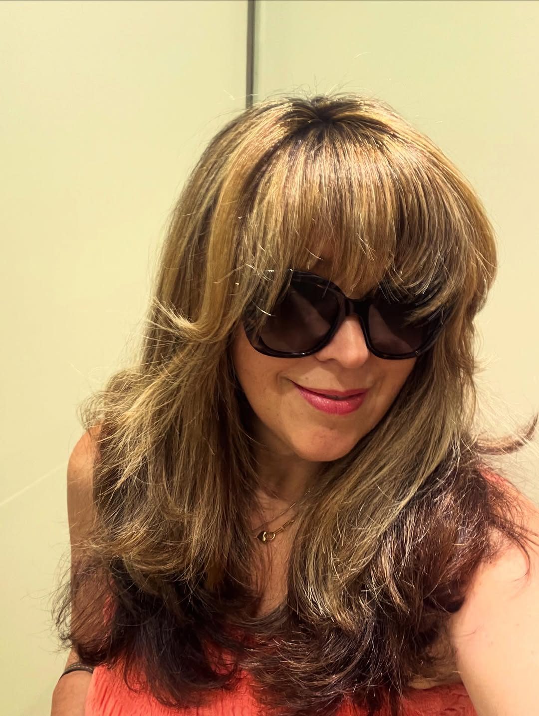 Brunette with soft Bardot bangs and a glossy finish
